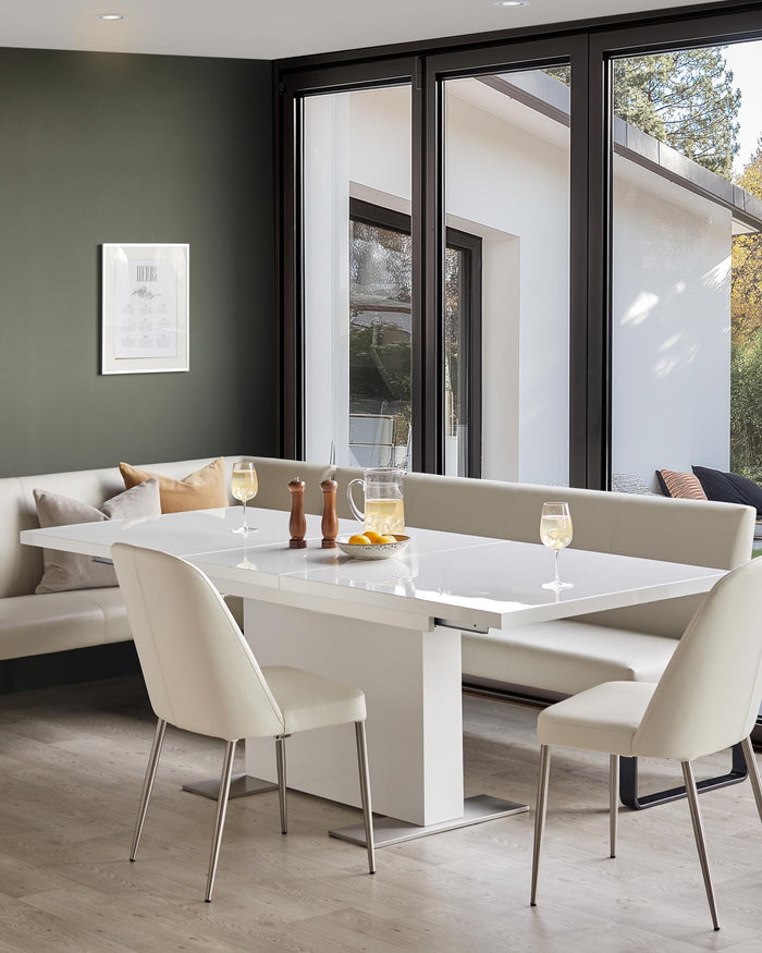 Contemporary dining area with a white extending table, bench seating and modern chairs. Perfect for family meals and entertaining.