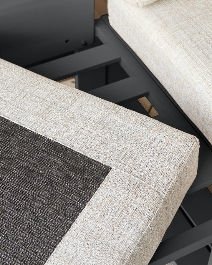 Close-up detail of Savannah Garden corner bench showing natural linen upholstery, black base, and storage compartment.