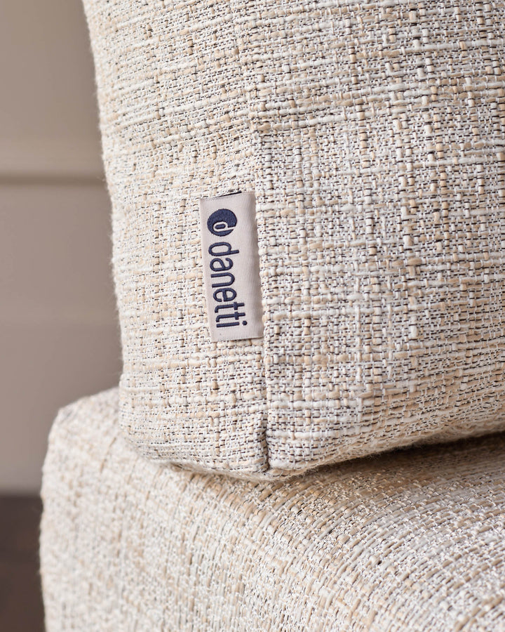 Cream textured fabric corner bench with Openiti brand label visible on the side seam.