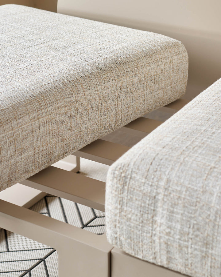 Savannah Garden corner bench with natural upholstery and beige base, close-up detail view.