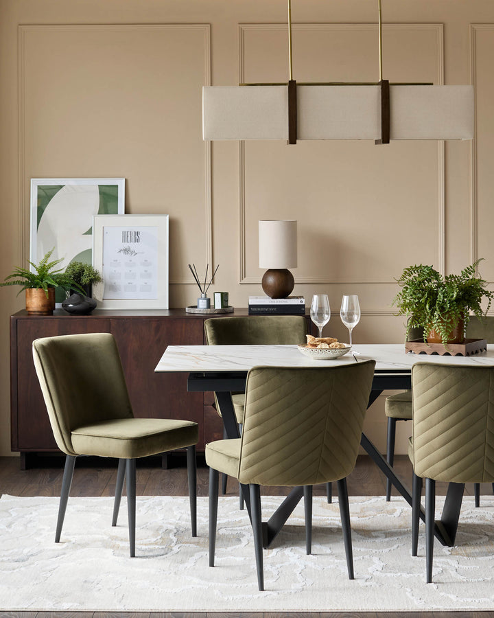 Dining room with modern olive green chairs, marble table, sideboard, and stylish lighting. Contemporary design.