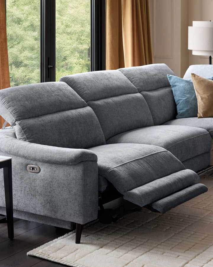 Serene right chaise recliner sofa in blue-grey chenille with footrest extended, shown in modern living room setting.