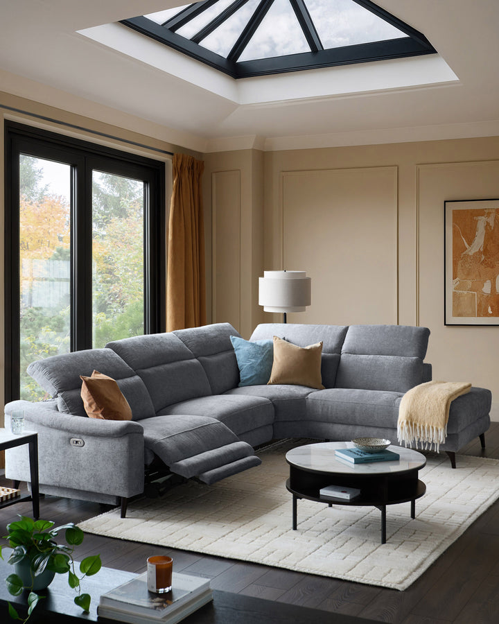 Grey chenille right chaise recliner sofa with extended footrest, displayed in modern living room setting.