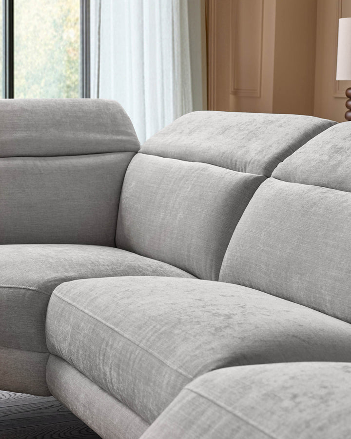 Serene left small corner recliner sofa in light grey fabric, close-up of plush cushioned seating and armrests in modern bedroom setting.