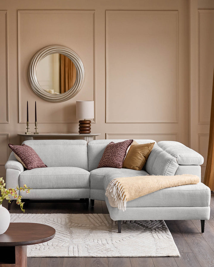 Light grey fabric right-corner recliner sofa with curved arms, displayed in a neutral living room setting with decorative pillows and throws.