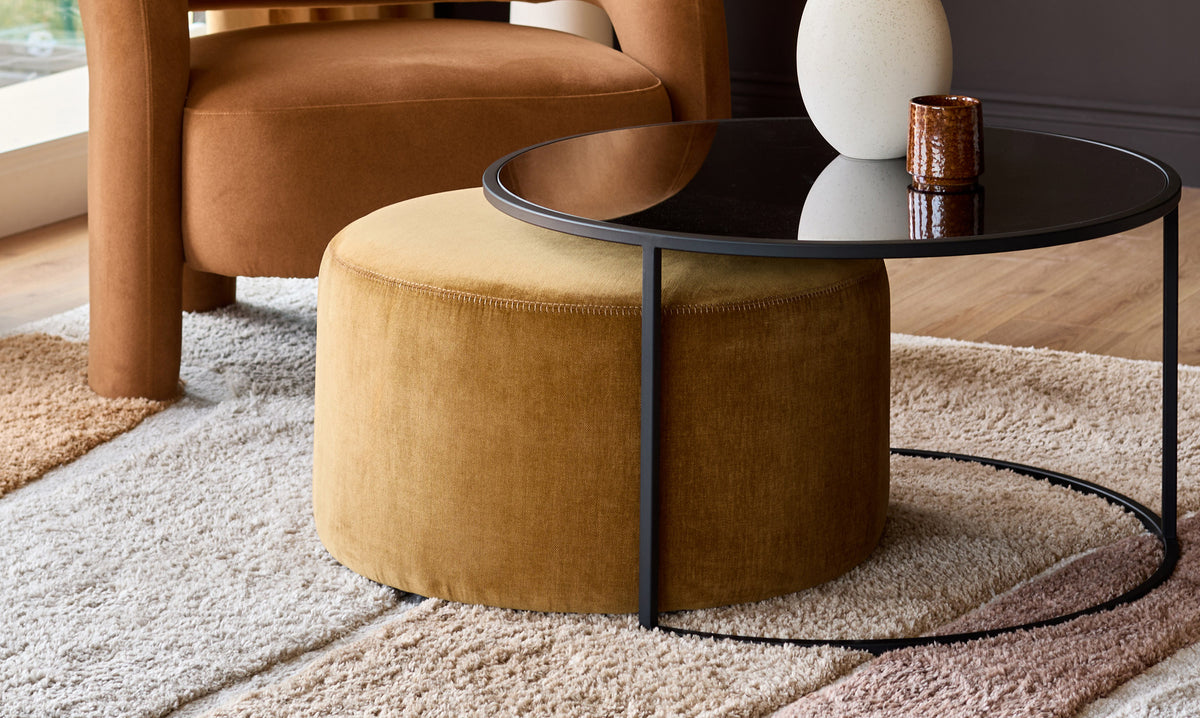 Thea smoked mirror coffee table and ochre fabric pouffe set