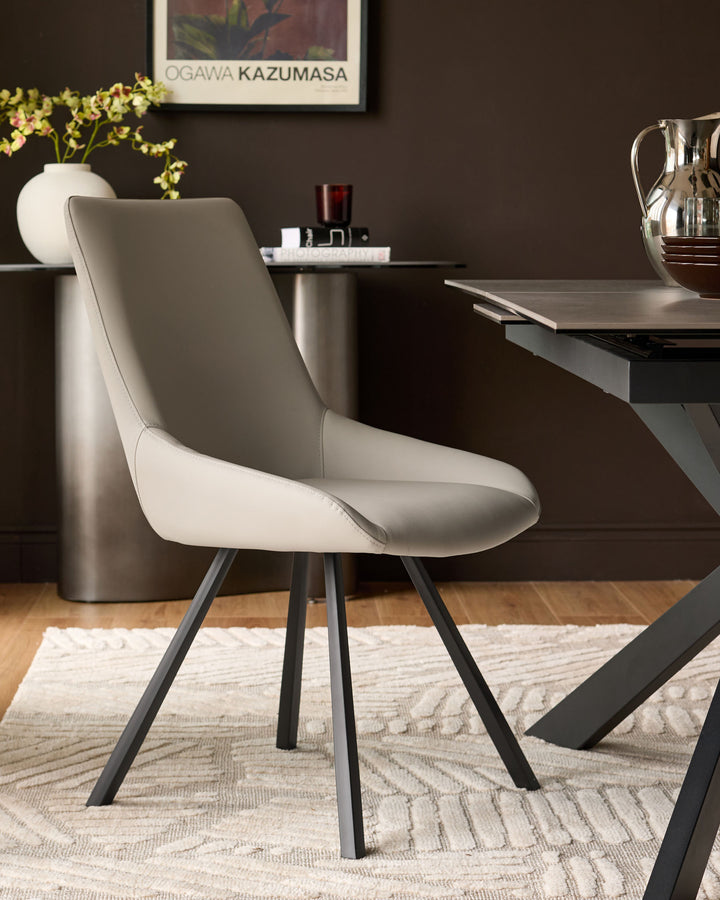 Cream textured area rug with geometric pattern displayed under a dining chair and table in a modern home office setting.