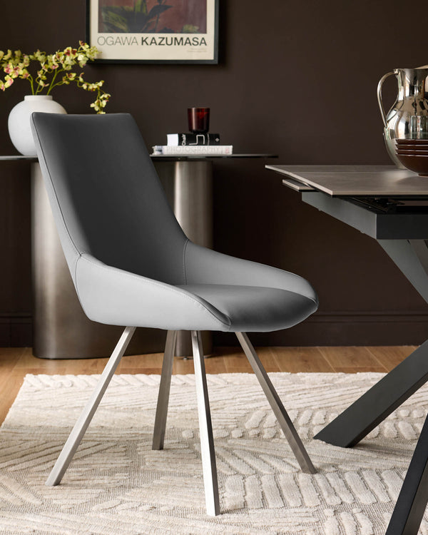 Theo faux leather dining chair in mid-grey and white with tapered metal legs, shown in a styled room setting.