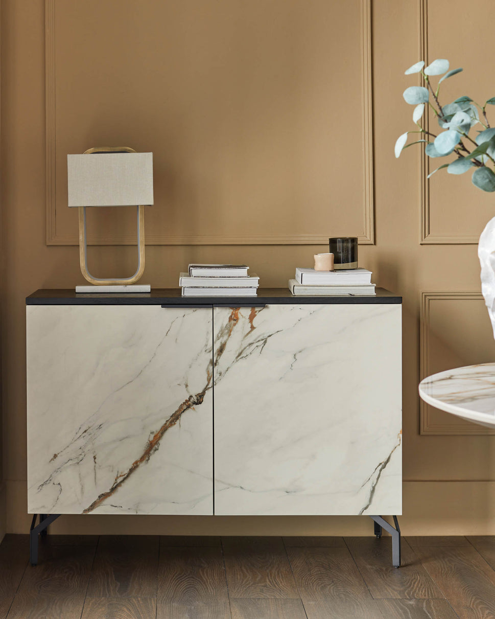 A stylish sideboard with marble-effect doors and a dark top, showcasing modern living room furniture.