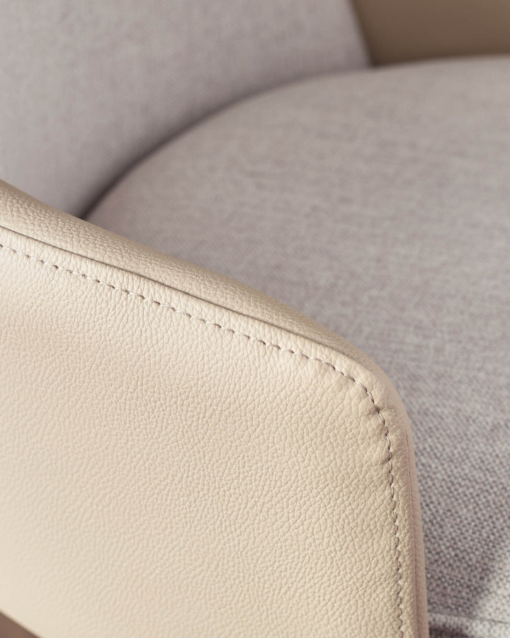 Close-up of cream faux leather seat with visible stitching detail on Wren gas lift bar stool.