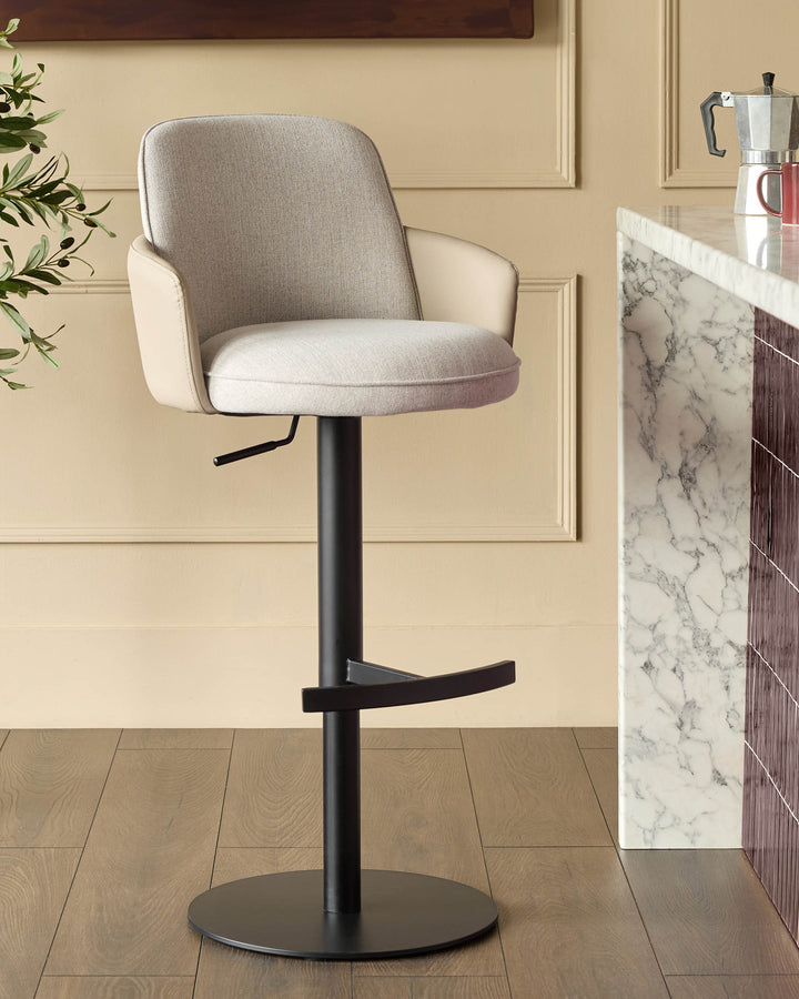 Wren gas lift bar stool in natural fabric with black metal base, shown in kitchen setting next to marble countertop.