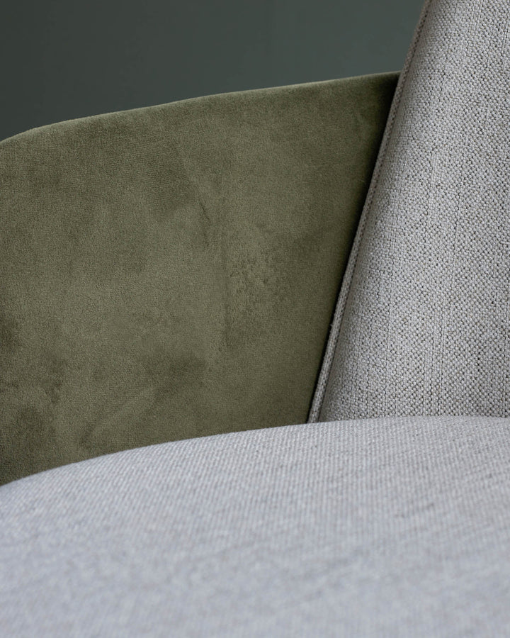 Close-up of a sofa with olive green and light grey textured fabrics. Modern furniture detail.