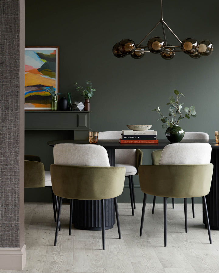 Dining room featuring a dark wood table, modern chairs with olive green and neutral fabric, and a stylish orb chandelier.