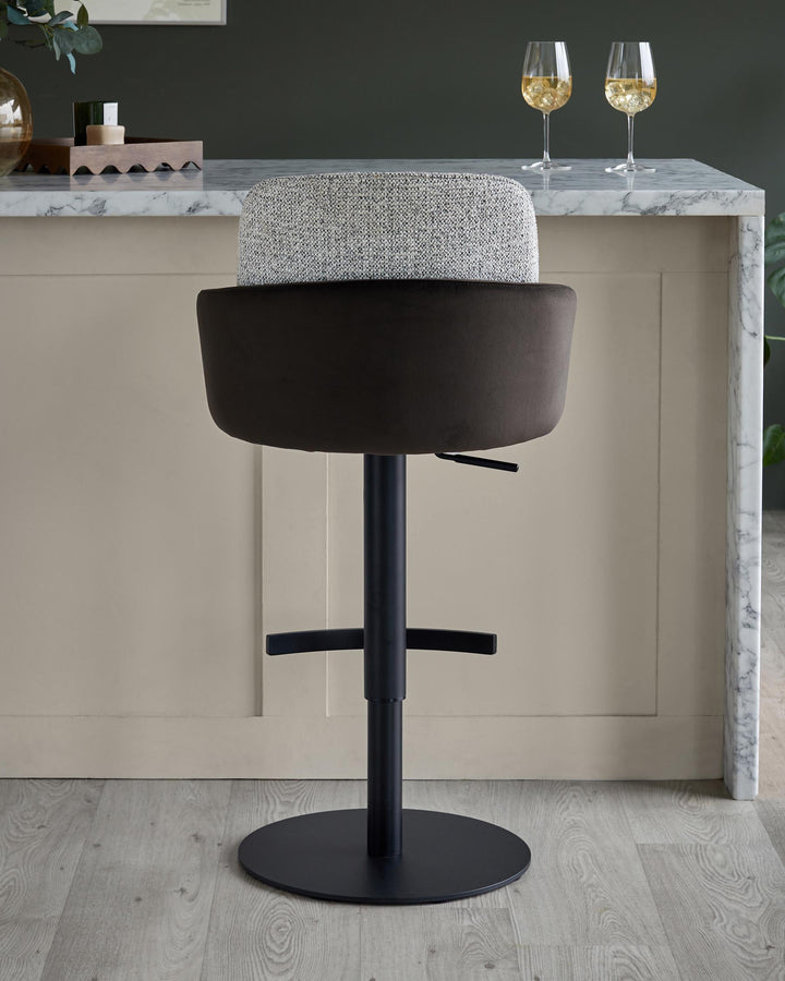 Stylish bar stool with a fabric seat and a black metal base, perfect for adding a touch of modern elegance to your kitchen.
