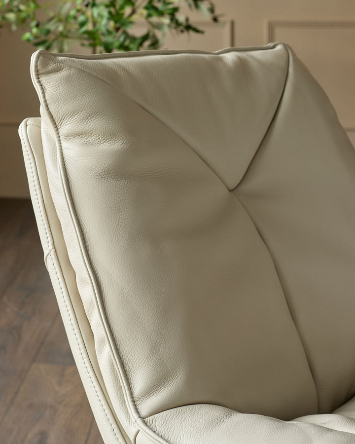 Cream leather upholstery detail showing quilted backrest and stitching on Zia swivel chair.