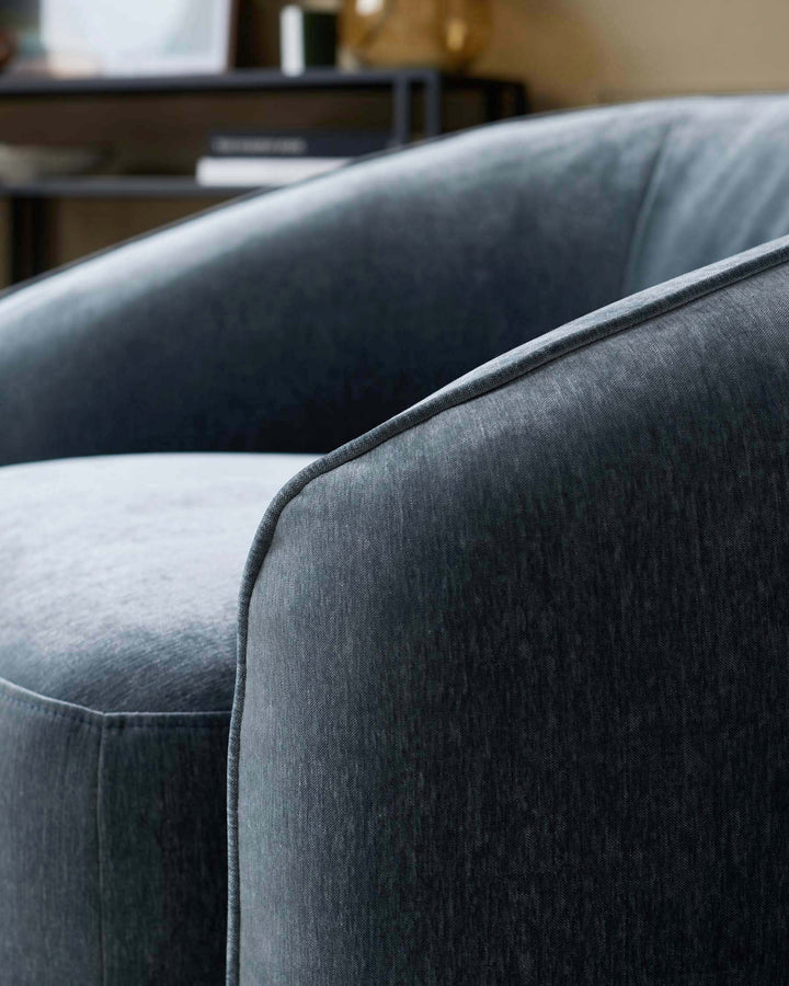 Close-up of a stylish blue upholstered armchair, showcasing its texture and modern design.