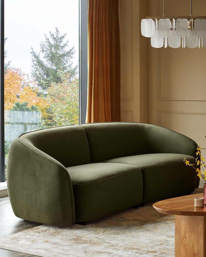 An olive green sofa and wooden coffee table grace a living space, bathed in natural light from a large window.