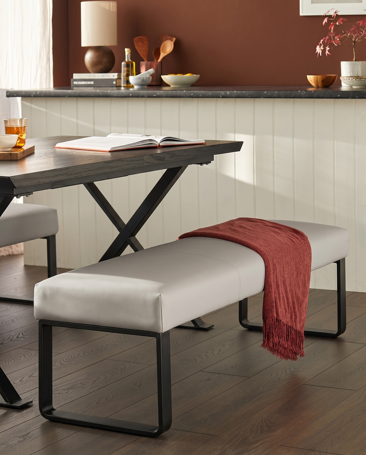 Loop 3-seater bench without backrest in light grey with black metal legs, displayed in a styled dining space.