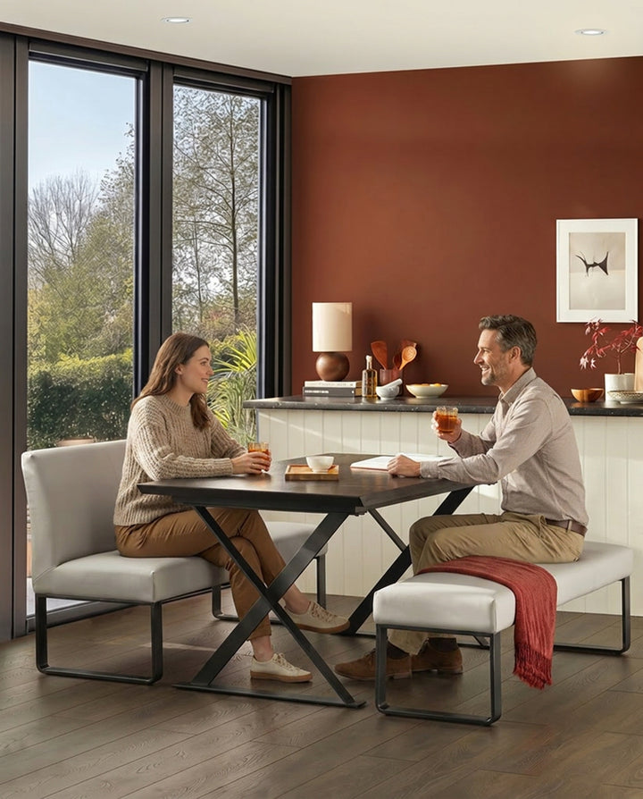 Loop 3-seater bench without backrest, light grey upholstery with black metal X-frame legs, shown in dining setting.