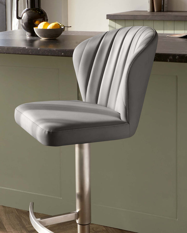 Modern adjustable bar stool with a curved, channel-tufted backrest and a cushioned seat in grey upholstery, set on a sleek metallic pedestal base with a footrest.