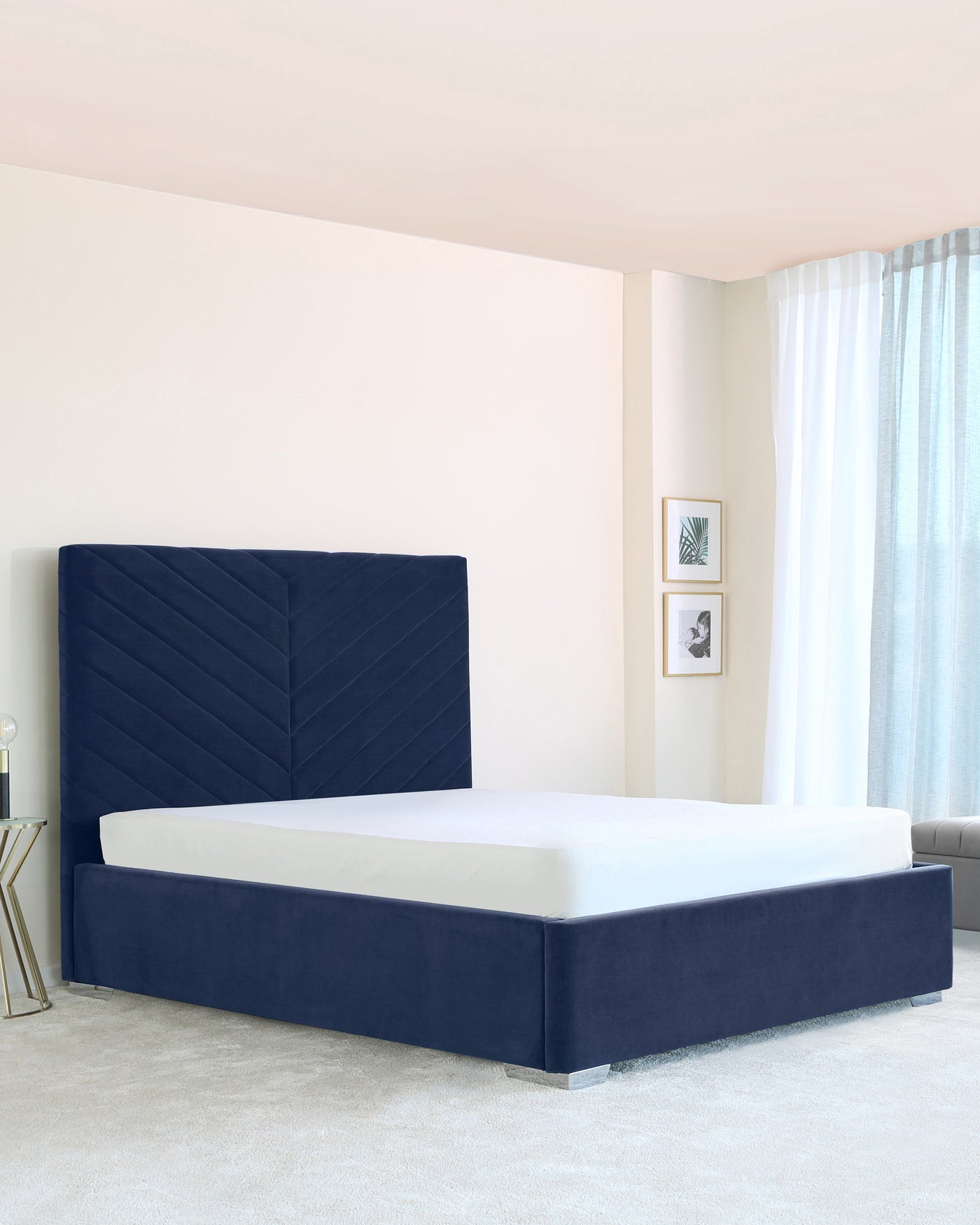 Elegant modern bedroom featuring a navy blue upholstered platform bed with a high, chevron-patterned headboard and matching base.