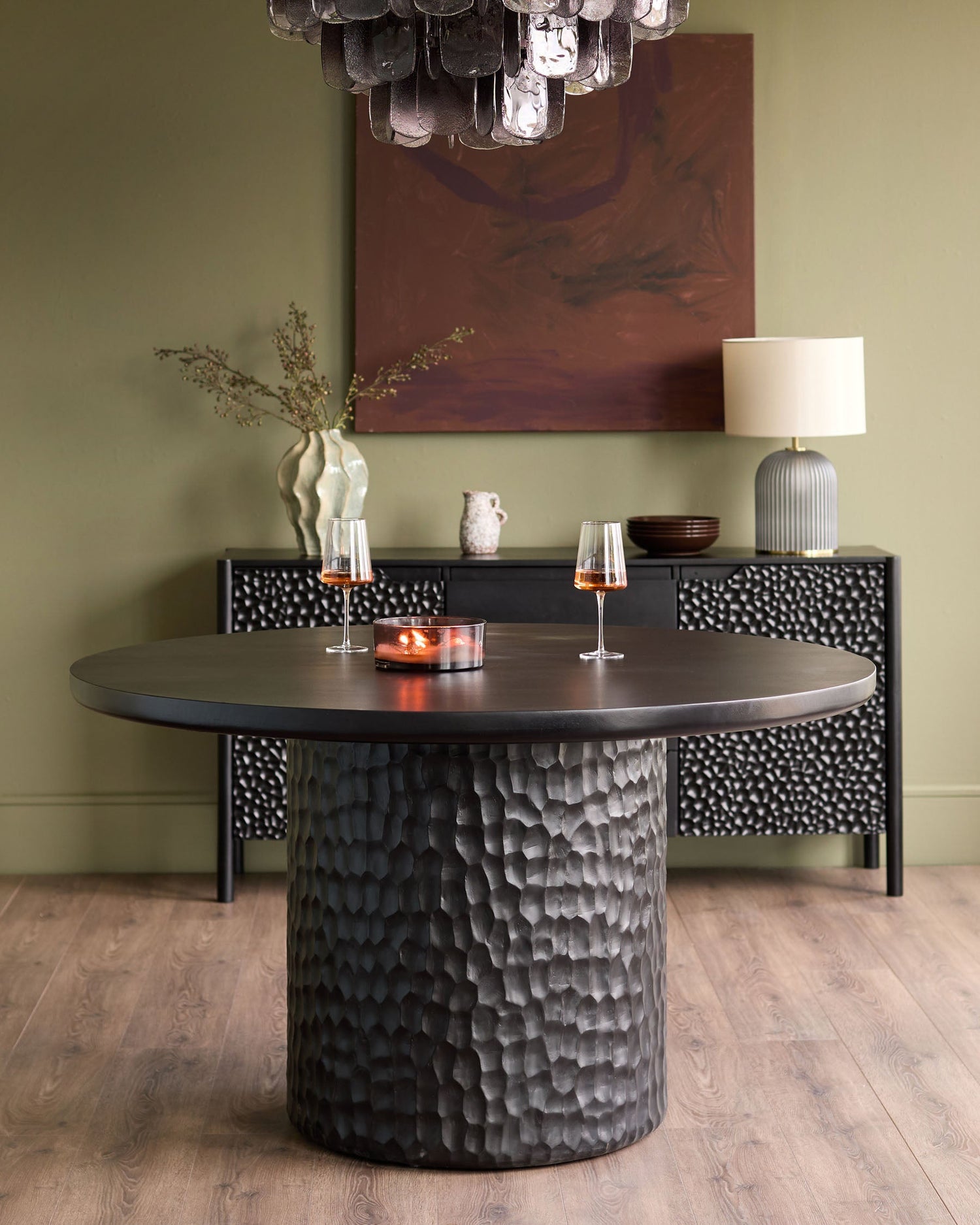 Knox 6-seater round dining table in black with textured hammered finish base and flat top surface.