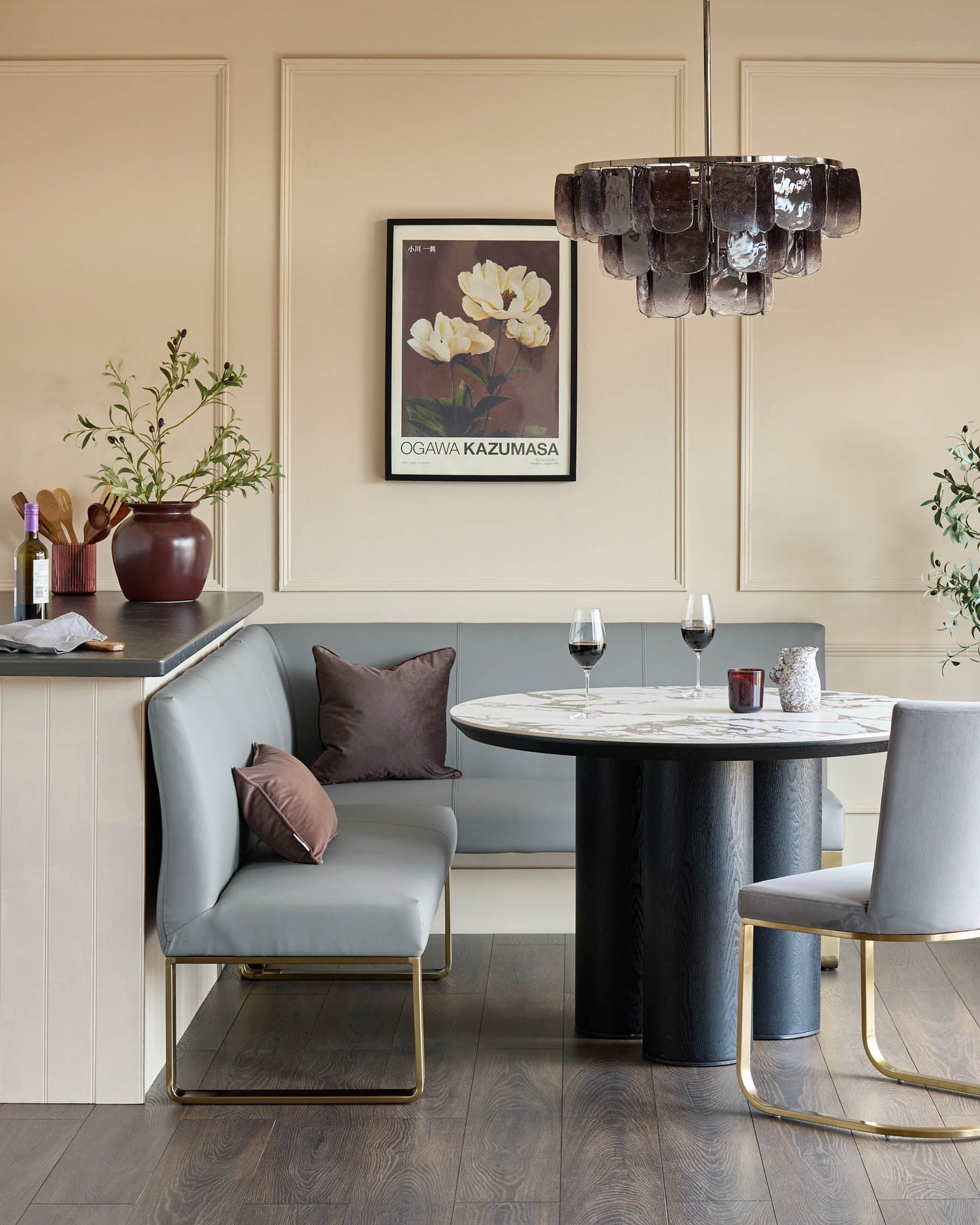 Loop 5-seater left-hand corner dining bench with brushed brass legs in mid-grey faux leather, styled in dining setting.