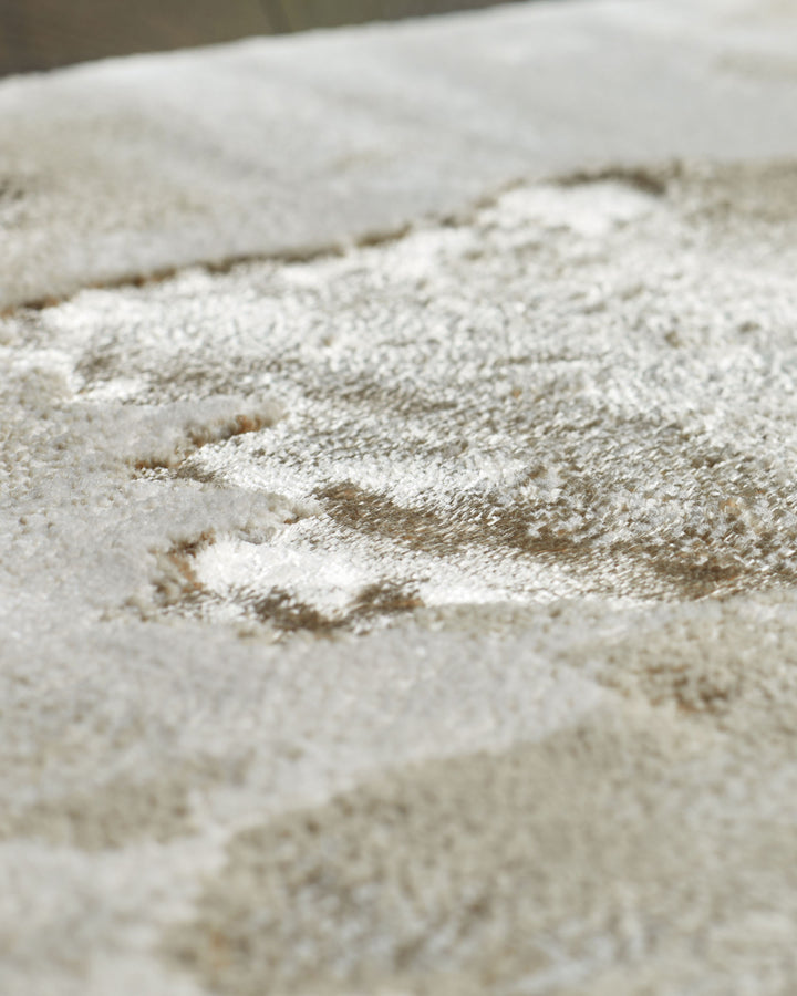 Close-up of a plush, textured rug in neutral tones. Great for adding warmth and comfort to any space.