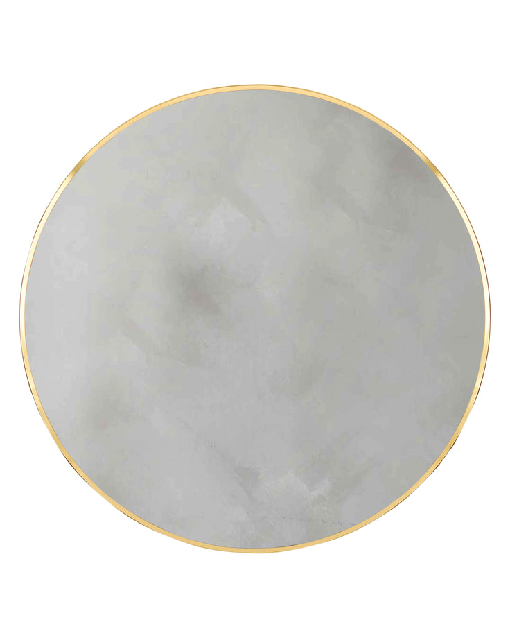 Large round wall mirror with gold frame and reflective grey-toned glass surface.
