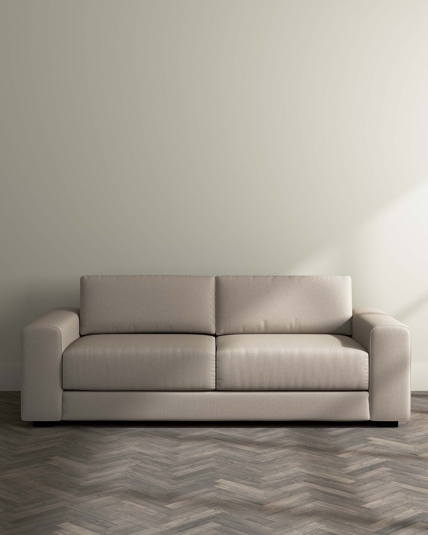 Modern minimalist beige three-seater sofa with clean lines and a smooth fabric finish, placed against a light neutral wall on a herringbone patterned wooden floor.