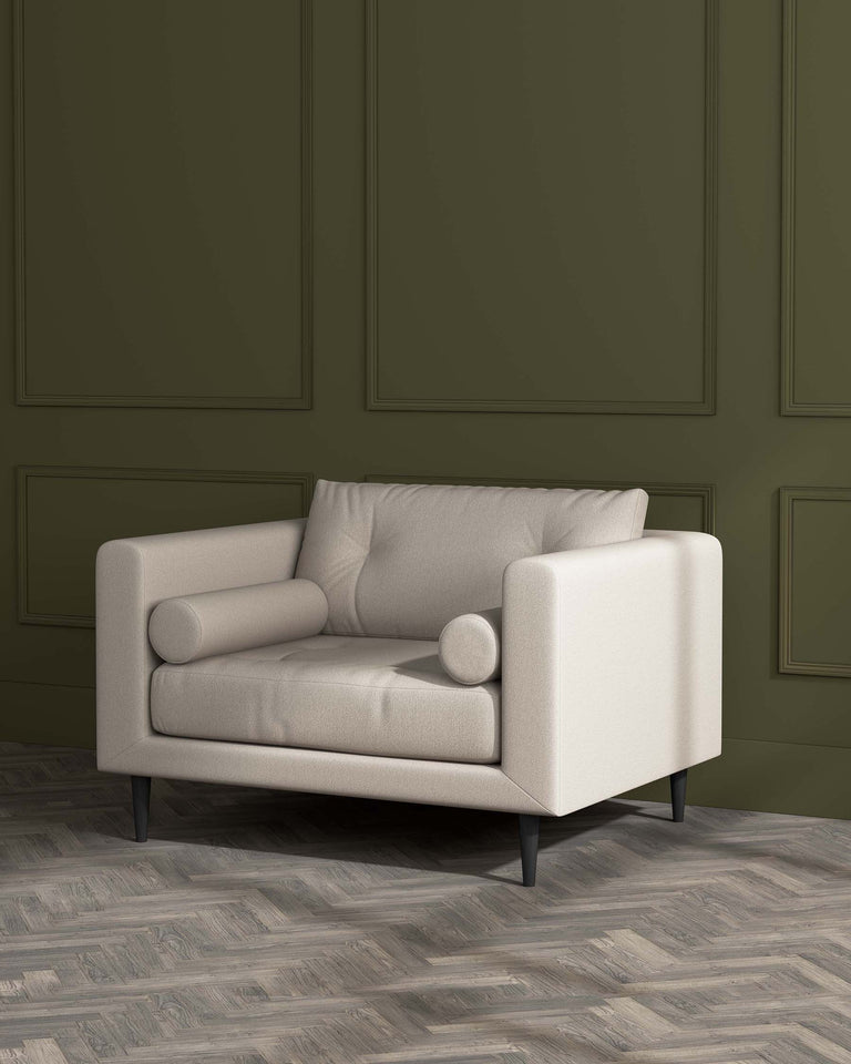 A modern beige single-seat sofa with clean lines, cushioned armrests, and dark, angled wooden legs. The sofa is set against a textured dark green wall panelling and rests on a herringbone-patterned wooden floor.