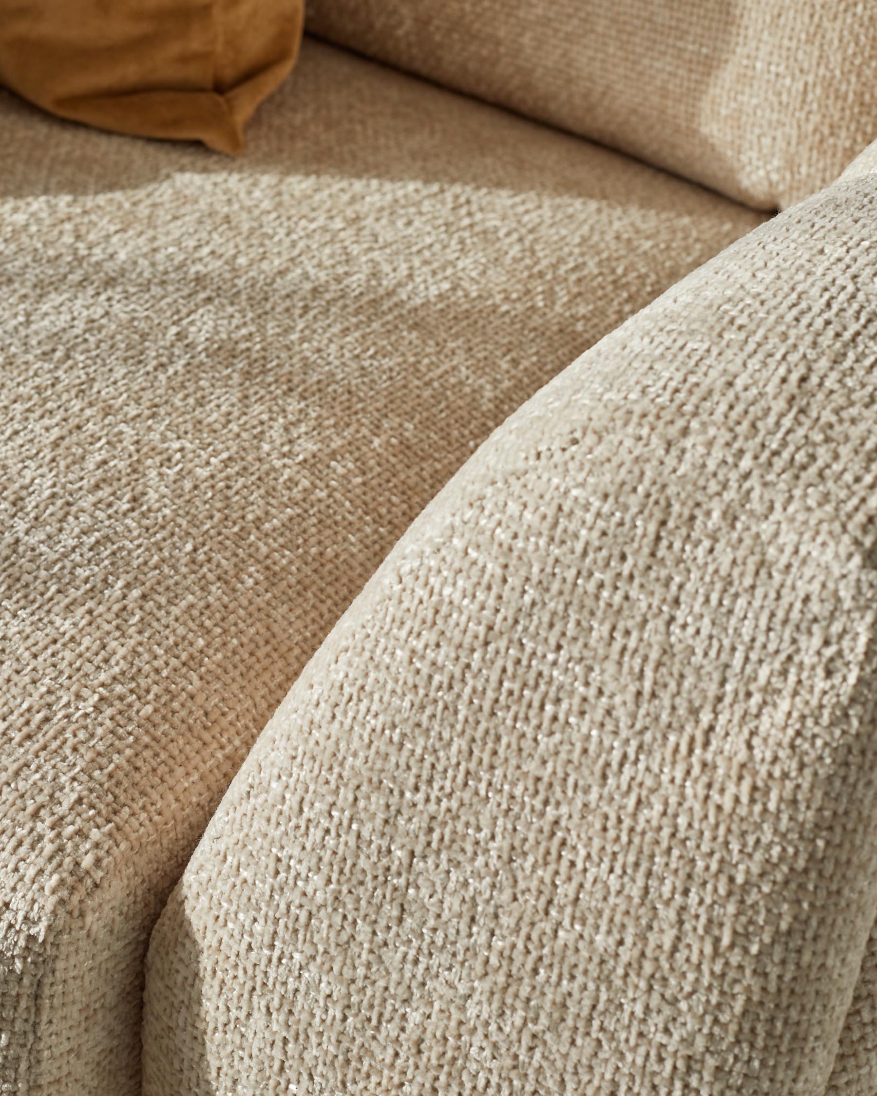 Close-up of natural weave fabric on Genevieve 2-seater sofa, showing textured beige upholstery detail.