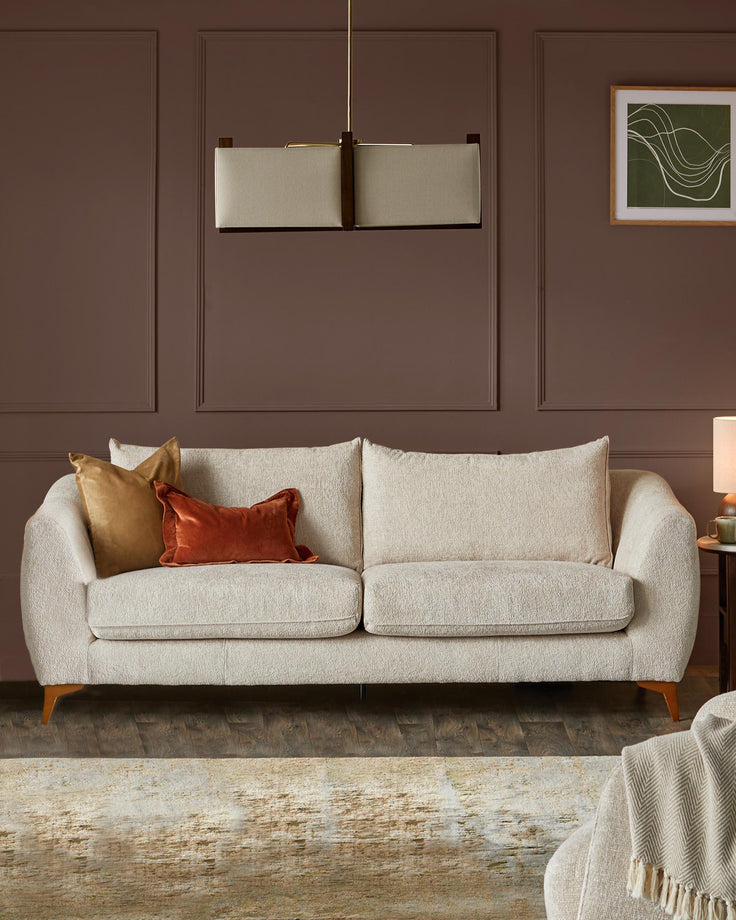 A comfy sofa with throw cushions in a modern living room setting with stylish lighting and decor.