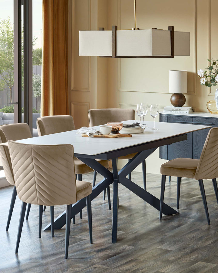 A dining room featuring a table with a white top and six plush chairs. Overhead, a modern, boxy light fixture illuminates the setting.