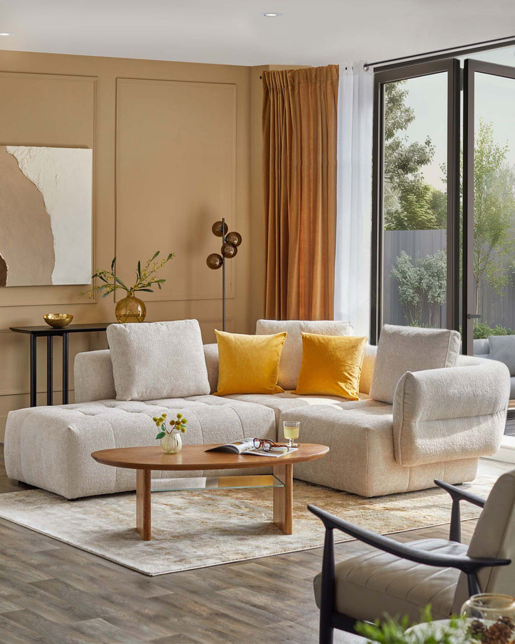 Luxe sectional sofa with yellow accent pillows, a round wooden coffee table, and a stylish armchair, set in a cozy living space.