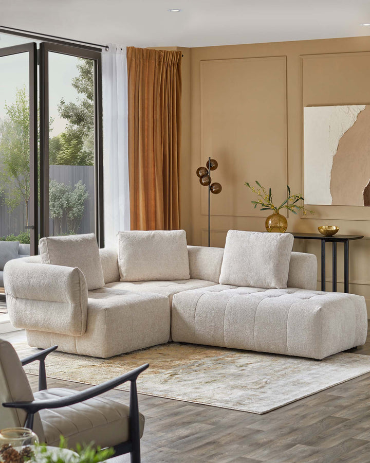 Modern sectional sofa in soft beige fabric, paired with a minimalist side table and a stylish floor lamp.