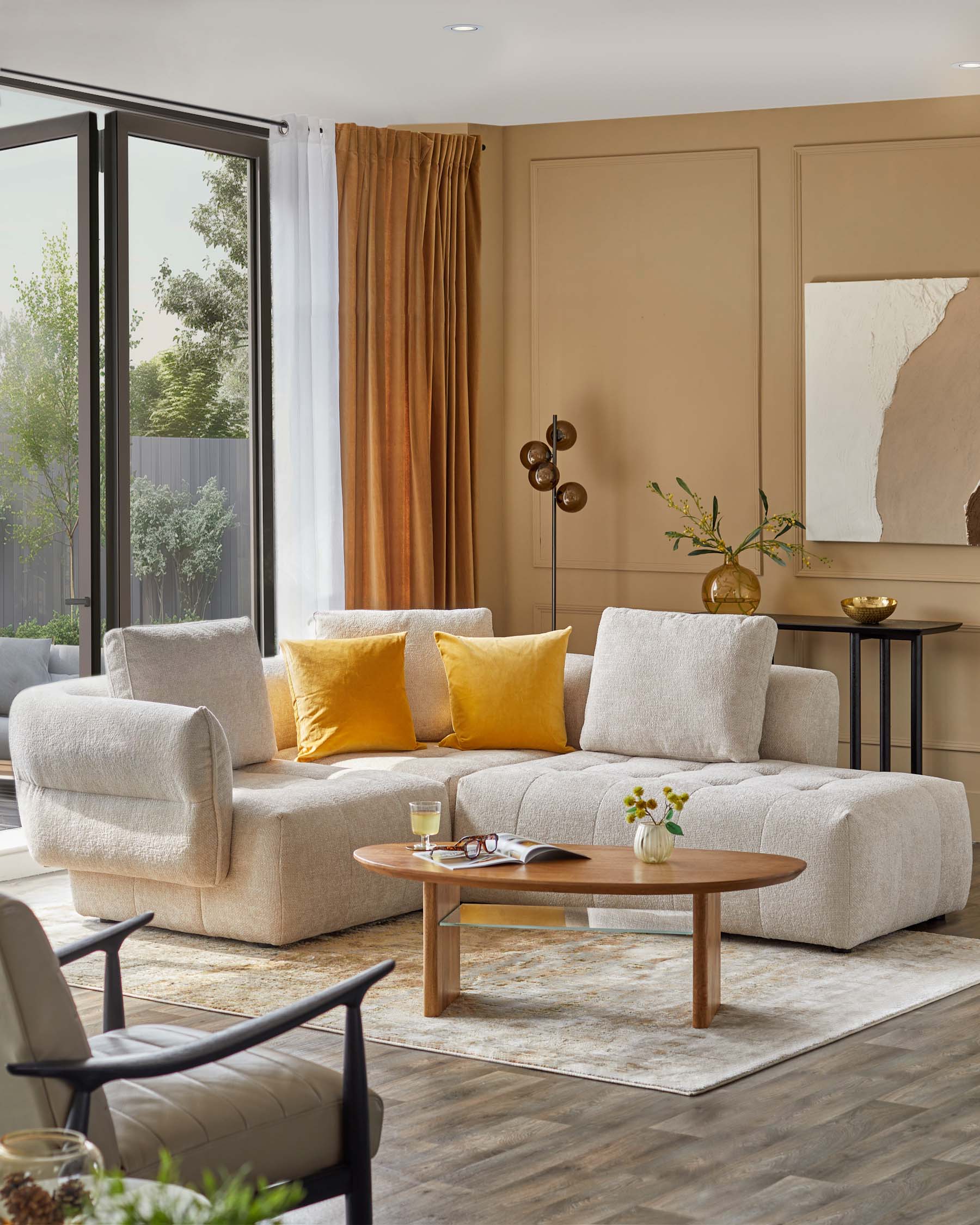 Cozy beige sectional sofa with yellow cushions, an oval wooden coffee table, stylish black lamp, and decorative vase.