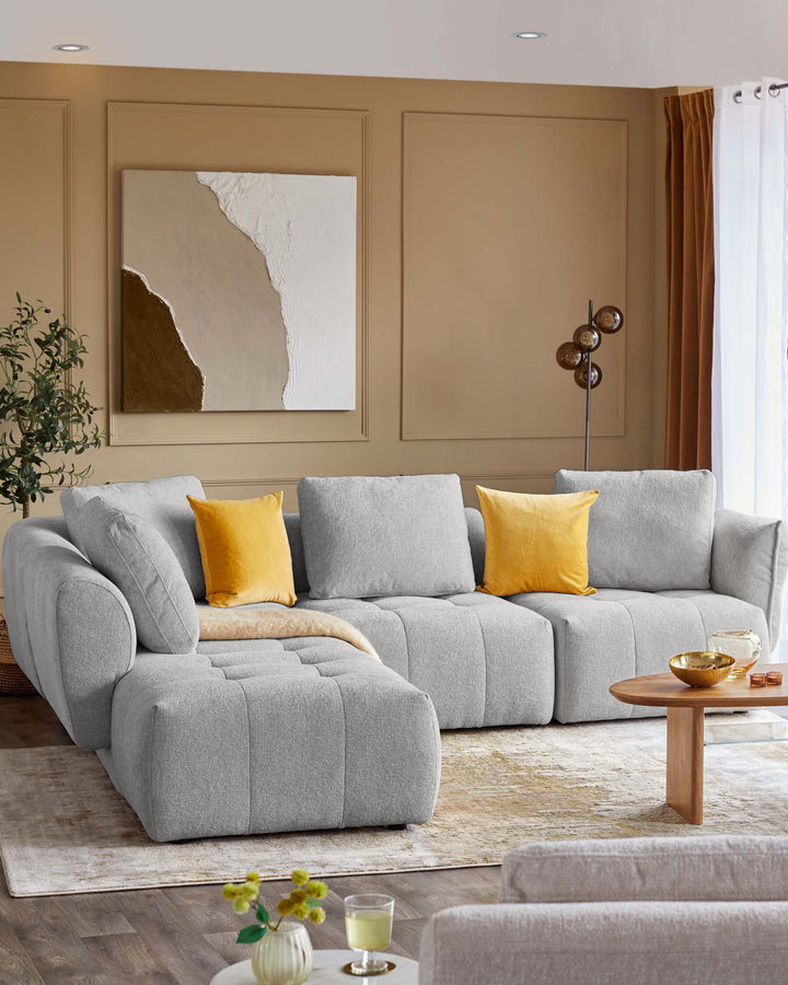 Lillian left corner chaise sofa in light grey weave, displayed in a modern living room setting with yellow accent pillows.