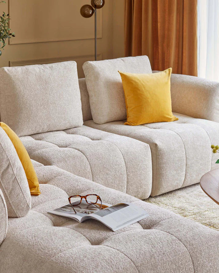 Lillian single module sofa in natural weave fabric, featuring quilted seat cushions and matching back pillows, styled with yellow accent pillows.