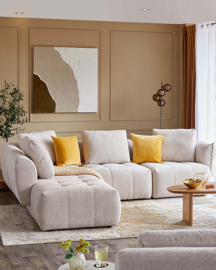 Plush beige sectional sofa with yellow accent pillows, paired with a light wood coffee table, set on a soft area rug.