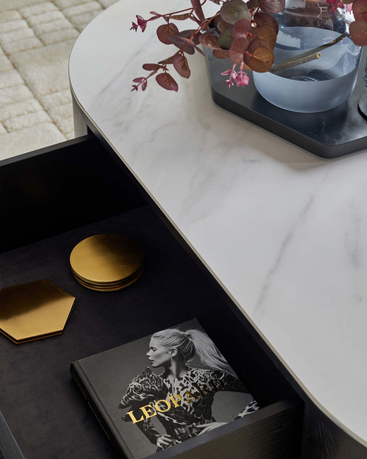 A stylish marble-topped coffee table with a sleek drawer showcasing contemporary design elements.