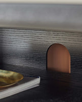 Close-up of a stylish desk with a cable management hole, showcasing its sleek design and practicality.