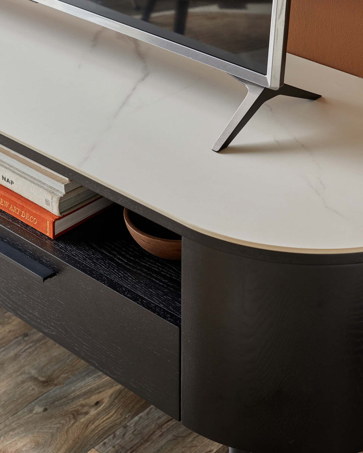 A stylish black TV unit with a faux marble top and curved edges, perfect for modern living rooms.