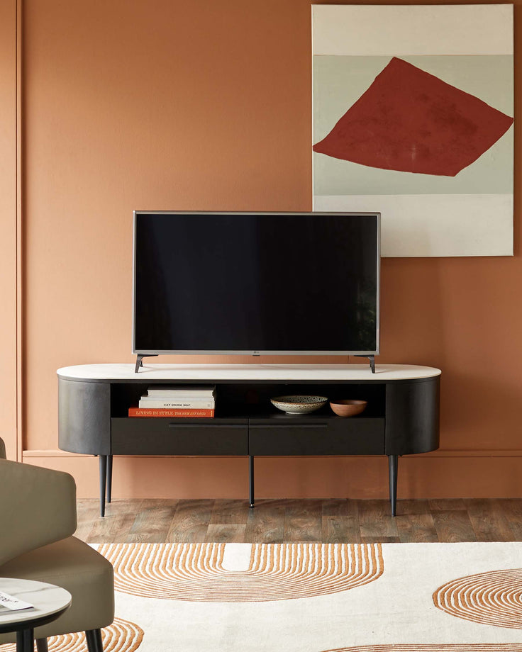Contemporary media unit with marble top and dark wood frame, housing a TV and decorative items, complemented by a patterned rug.