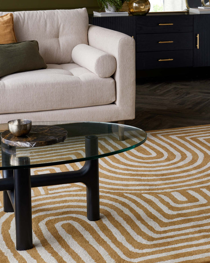 Stylish living room furniture featuring a modern sofa, glass coffee table and sleek black sideboard.