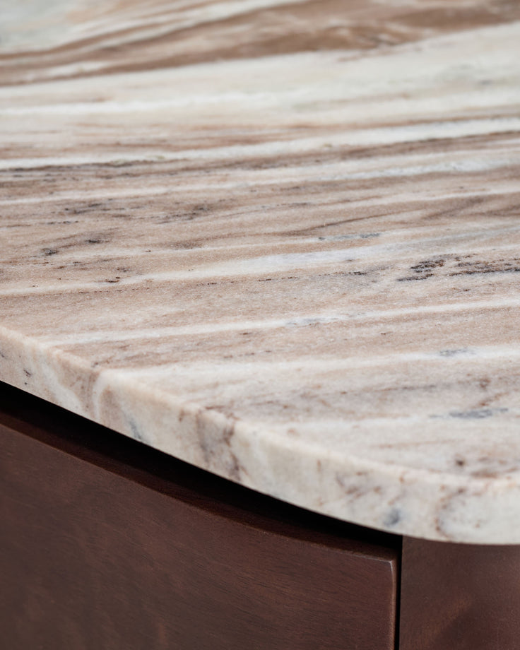 Adalynn bedside table with light marble top and dark wood base, angled detail view.