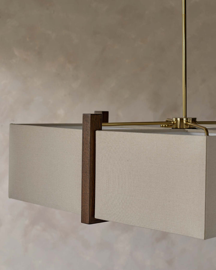 Close-up of a stylish, contemporary light fixture with a rectangular lampshade and dark wood accents.