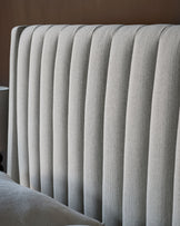 Amalfi fabric double bed with storage in ivory, showing close-up of vertical channel quilting on headboard.