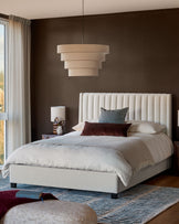 Amalfi Fabric Double Bed in ivory with vertical channel tufting on headboard, displayed in a styled bedroom setting.