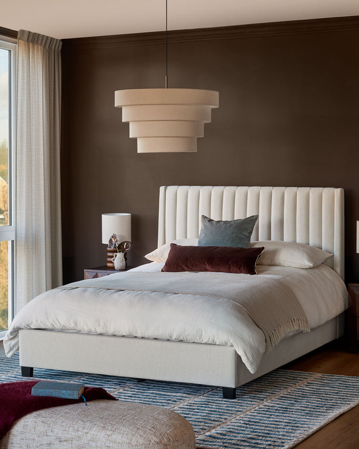 Amalfi Fabric Double Bed in ivory with vertical channel tufting on headboard, displayed in a styled bedroom setting.